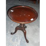 Circular topped occasional table on tripod feet