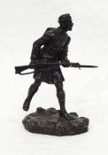 A bronze model of WWI soldier carrying rifle, signed indistinctly "G L Movio, London, 1915"(?),