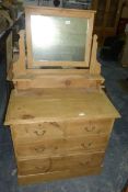 A pine chest of two short and two long graduated drawers,