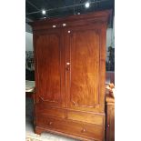 An early 20th century Howard & Son mahogany bedroom suite viz:- dressing table, hanging wardrobe,