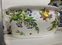 A 19th century china two-handled foot bath with handpainted floral and fruit decoration (damaged)