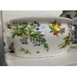 A 19th century china two-handled foot bath with handpainted floral and fruit decoration (damaged)