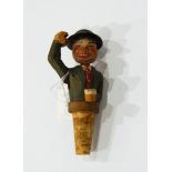 A carved wooden novelty bottle stopper of man with drink nodding his head