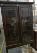 A mahogany glazed fronted display cabinet with three shelves, on plinth and block feet,