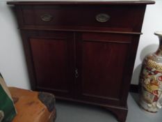 A mahogany cabinet fitted with single drawer over cupboard doors, on bracket feet,