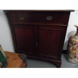 A mahogany cabinet fitted with single drawer over cupboard doors, on bracket feet,