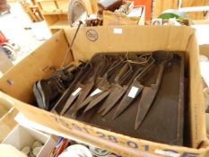 A large quantity of iron shearing scissors, 19th century steel yard with shaped pans, etc.