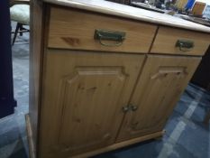 An oak chest of three long drawers, on shaped bracket feet,
