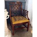 A Chippendale style stained fruitwood open armchair with stylised back and arm rests,