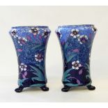 Pair of Mailing footed vases, with floral decoration in blues and purples,