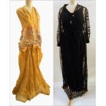 A vintage silk gauze evening dress in gold, halter neck, with the bodice embroidered with flowers,