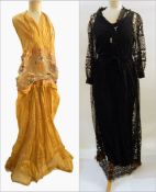 A vintage silk gauze evening dress in gold, halter neck, with the bodice embroidered with flowers,