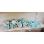 A quantity of Poole tableware with a grey glaze and turquoise interiors,