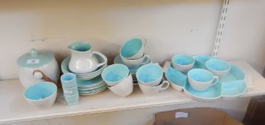 A quantity of Poole tableware with a grey glaze and turquoise interiors,