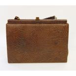A vintage crocodile handbag with matching purse,