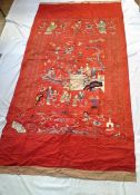 A late 19th century Chinese embroidered silk temple hanging, red ground with figures,