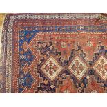 An Eastern rug with three central medallions, on blue field within multiple borders,