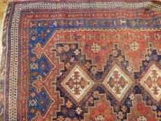 An Eastern rug with three central medallions, on blue field within multiple borders,