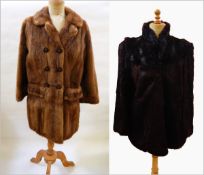 A three-quarter length mink coat with pockets and buttons and patterned lining together with a dark