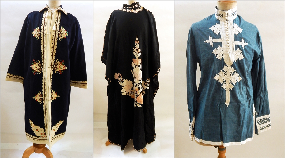 A kaftan style short blue top with white embroidery and buttons,