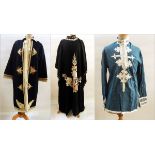 A kaftan style short blue top with white embroidery and buttons,
