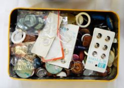 Two vintage tins containing buttons,