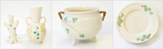 A Belleek jardiniere of cauldron form, with two handles, on three feet, decorated with clover, 13.