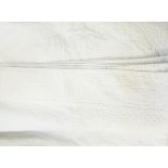 A large quilted cream bedspread with American style applique