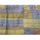 A 20th century quilted bedspread of geometric design in blue,