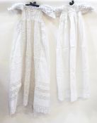A selection of christening gowns, many with lace trim, broderie anglaise, etc.
