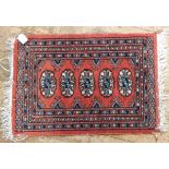 An Eastern style woollen prayer mat and another Eastern style small rug with linen fringe (2)