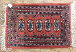 An Eastern style woollen prayer mat and another Eastern style small rug with linen fringe (2)