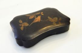 A lacquered box of shaped rectangular form, decorated with a bird on a branch,