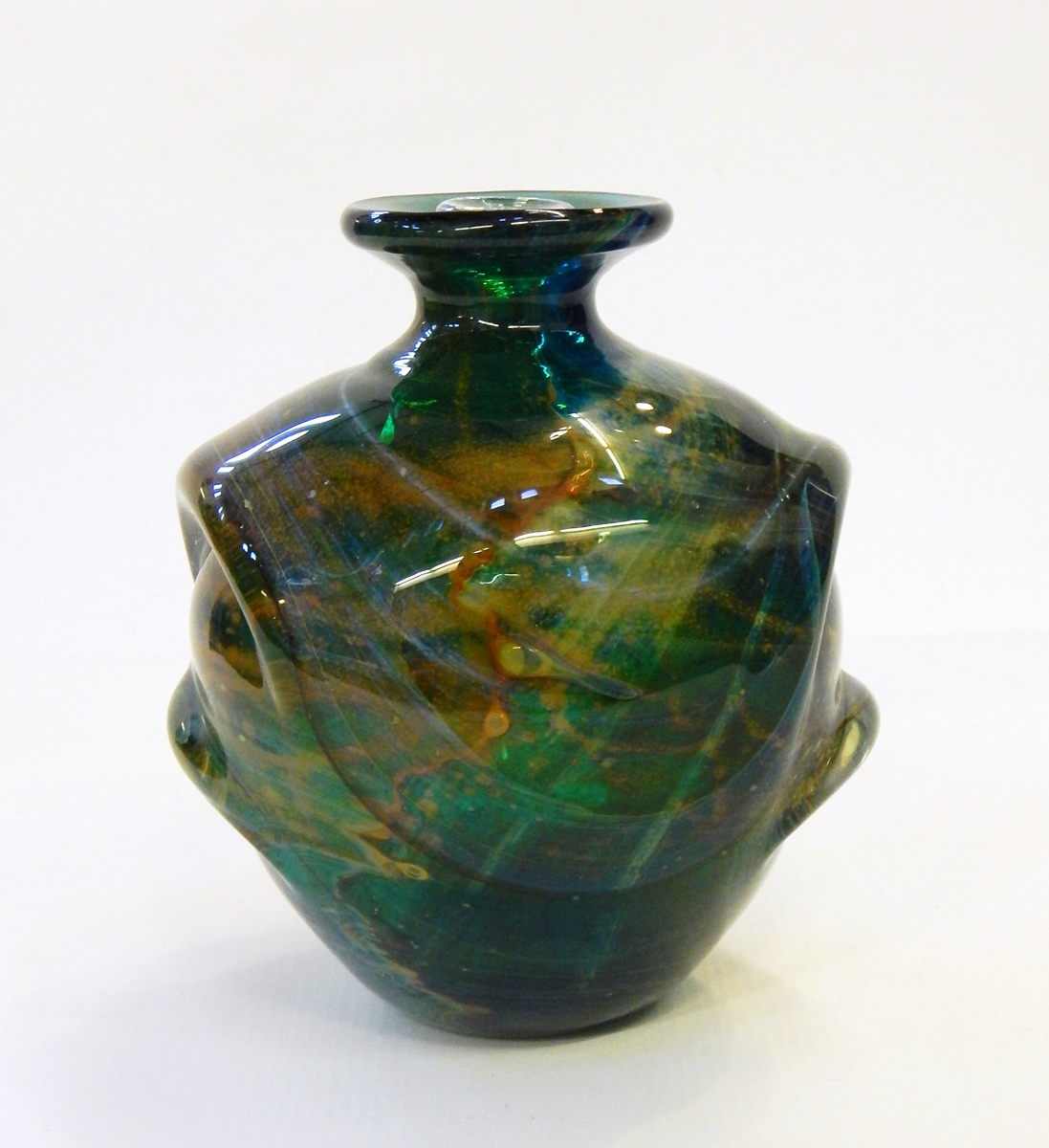 A Mdina glass vase and stopper of swirling designs in brown and yellow, on green ground,