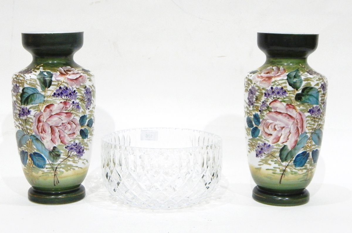 A pair of Victorian white glass vases painted with flowers and with green neck and foot,