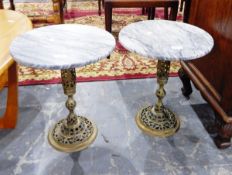 A pair of circular marble top wine tables on pierced brass pedestals (2)