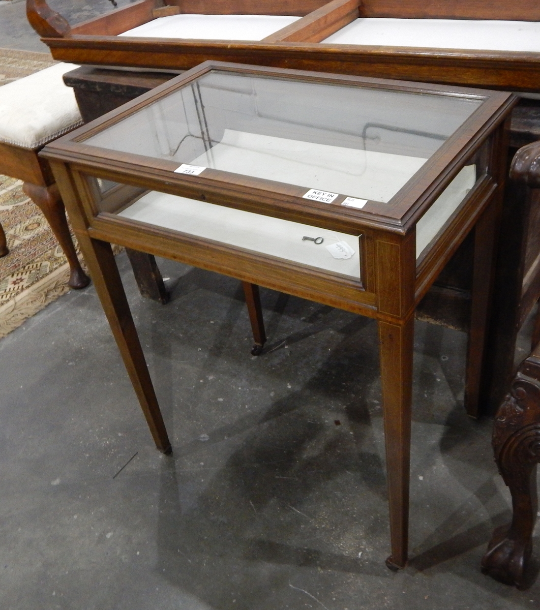 A 20th century mahogany veneered display cabinet with strung borders,