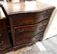 A 20th century mahogany veneered and cross-banded serpentine-fronted chest of four drawers on