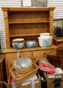 A 19th century pine kitchen dresser with two short drawers, cupboard to underneath, on block plinth,