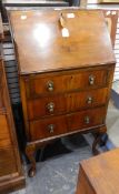 A mid 20th century lady's mahogany veneered bureau with pigeonhole interior over three drawers and