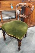 A Victorian mahogany balloon back dining chair with scroll carved splat,