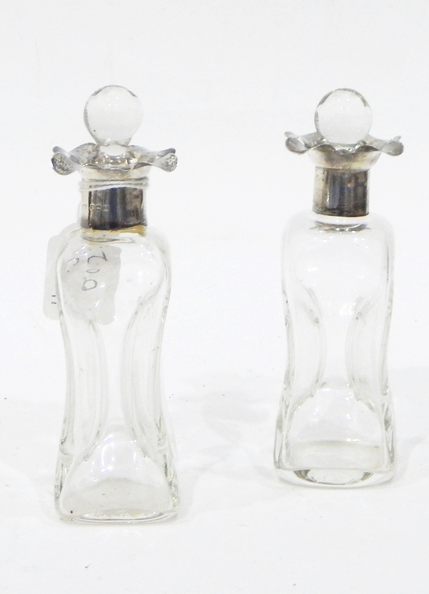 A pair of glass scent bottles of waisted form, with silver collars, - Image 2 of 2