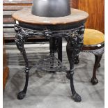 A circular mahogany topped pub table with cast iron ornamental base and with under-tier,