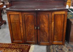 A 19th century mahogany cabinet enclosed by flame mahogany doors, 123cm (af) (door hanging off,