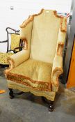 A high back wing armchair on bobbin and block supports with bun feet, united by X-stretchers,