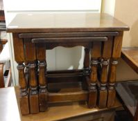 A nest of three oak tables on turned baluster supports and an oak blanket chest with triple