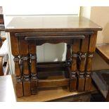 A nest of three oak tables on turned baluster supports and an oak blanket chest with triple