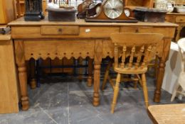 An oak sideboard with two short frieze drawers, with shaped apron,