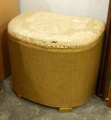 A Lloyd loom style linen basket with upholstered top