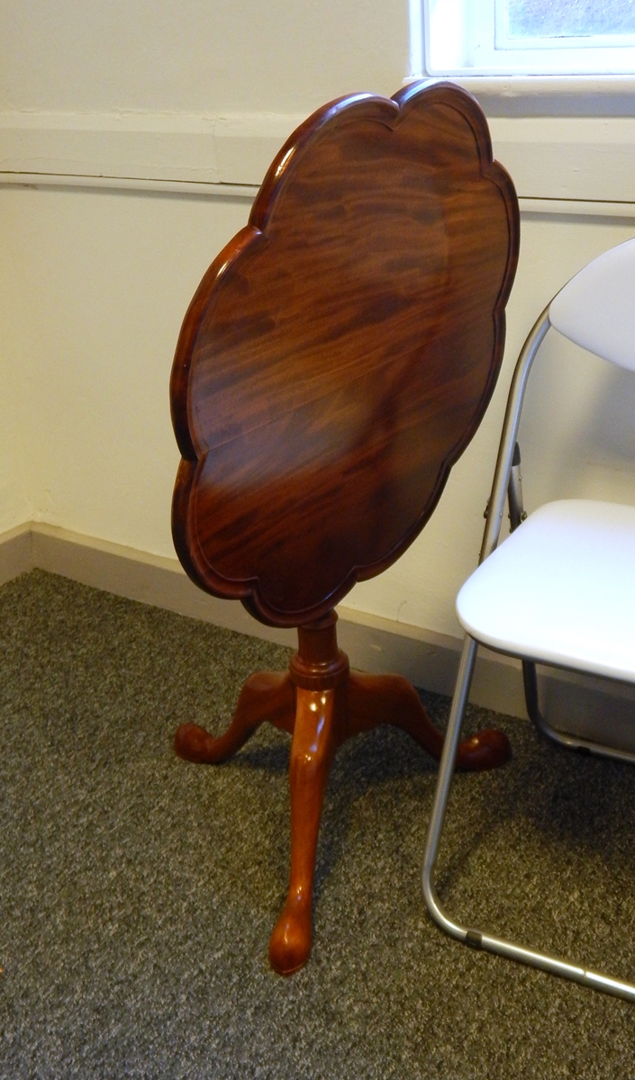 A mahogany snap-top tripod occasional table with scalloped circular top